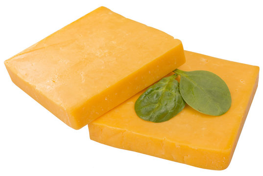 two slices of cheddar decorated with arugula isolated
