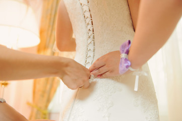 Bridesmaids Tying Corset