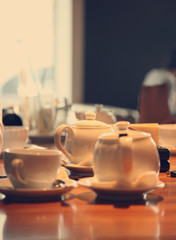 table in cafe with cups and teapot,  image with selective focus