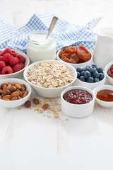 oat flakes and various ingredients for breakfast on white