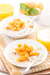 plates of oatmeal with fresh apricots and nuts, orange juice