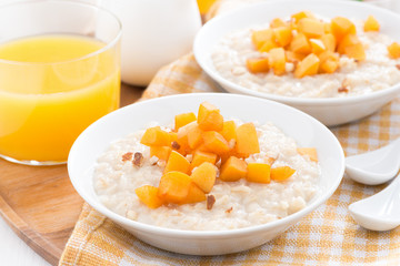 plates of oatmeal with fresh apricots and nuts, orange juice