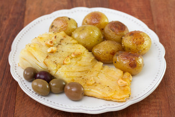 codfish with potato on plate