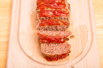 Fresh Baked Meatloaf Sliced on Wood Cutting Board