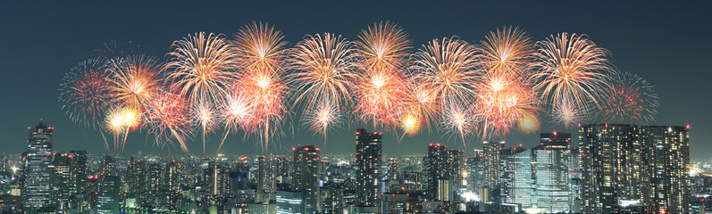 Fireworks celebrating over Tokyo cityscape at night, Japan