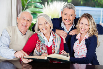 Happy Family With Book In Nursing Home