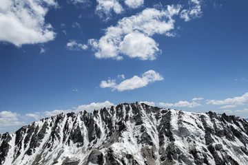 Snow covered sharp mountain ridge
