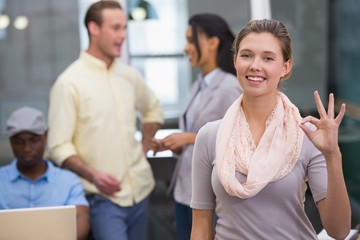 Smiling businesswoman with colleagues in office