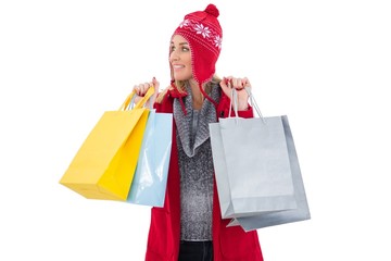 Blonde in winter clothes holding shopping bags