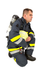 Fireman in uniform isolated in white