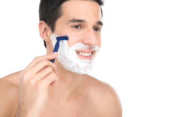 Close up of male shaving with razor on white background.