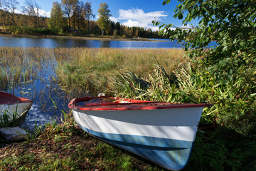 Autumn lakes at Norway abandoned boat
