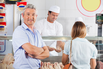 Confident Man In Butcher's Shop
