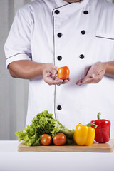 Chef holds Tomato