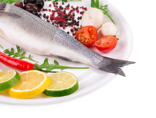 fish on a plate with vegetables