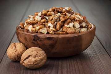 walnuts in the brown wooden bowl