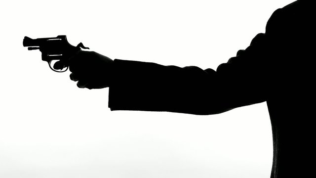 man shooting a handgun,real time,isolated,studio lighting