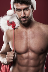 Hot manly santa claus with christmas sack
