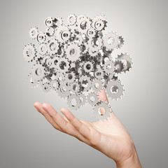 businessman hand showing gears cogs to success concept