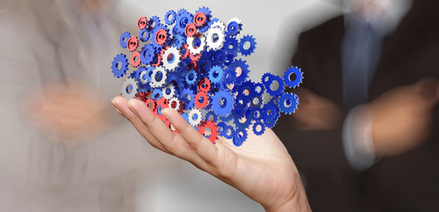 businessman hand showing gears cogs to success concept