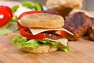 Homemade cheeseburger with a fresh lettuce and red pepper