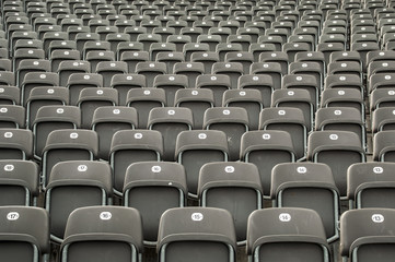 Empty gray plastic seats in a stadium