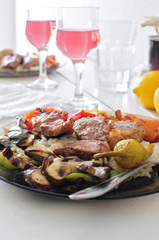 Fototapeta na wymiar Dish with meat and vegetables served with rose wine
