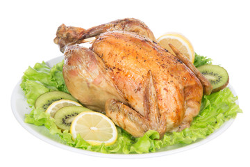 Garnished roasted thanksgiving chicken on a plate decorated with