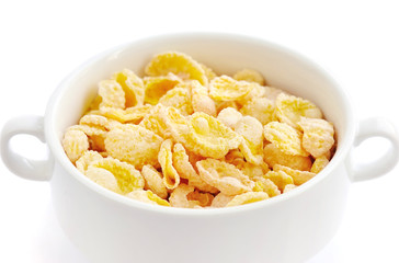 Cornflakes in bowl on white background