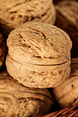 Whole walnuts in a wicker basket close-up