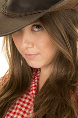 cowgirl red white shirt close look with one eye under hat