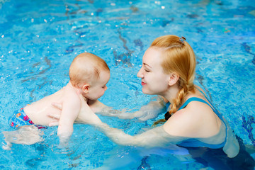 mother with her son in the pool. Swimming lessons for children