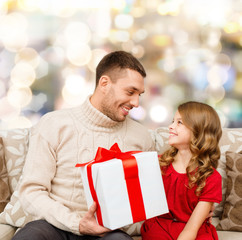 smiling father and daughter with gift box