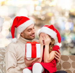 smiling daughter waiting for present from father