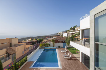 Balcony with ocean and pool view in the modern villa