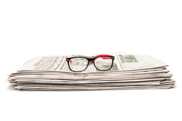 newspaper with glasses closeup