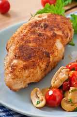 Chicken fillet in crispy breadcrumbs garnished with mushrooms an