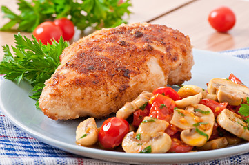 Chicken fillet in crispy breadcrumbs garnished with mushrooms an