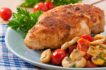 Chicken fillet in crispy breadcrumbs garnished with mushrooms an
