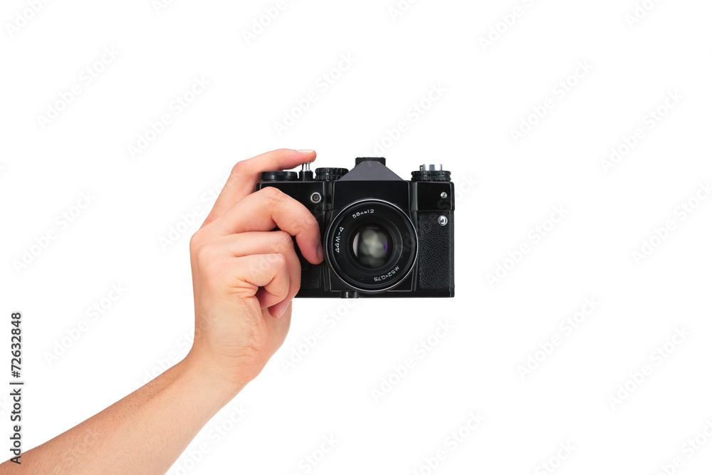 Wall mural Vintage camera in hand on white background