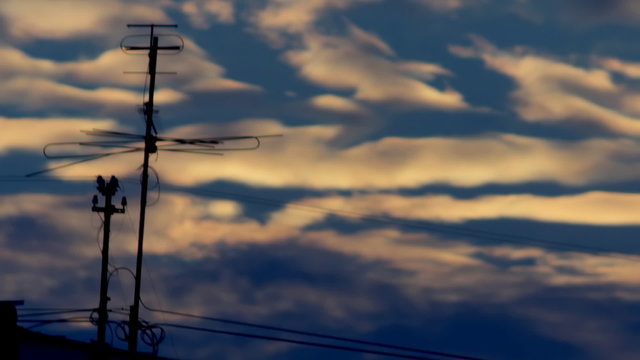 silhouette of TV antenna against the background of a sunset