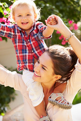 Obraz premium Portrait Of Mother And Daughter Playing Outside Together