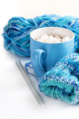Obraz na płótnie Canvas Homemade knitting and a mug of hot chocolate