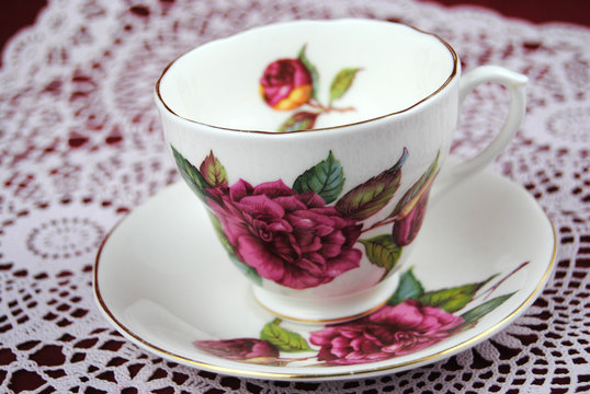 Antieke kop en schotel met bloemen en een gouden randje