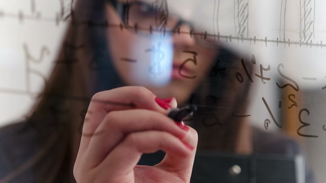 Female student writing math formulas
