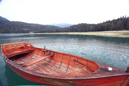 wooden boat on a mooring mountain lake