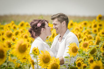 Beautiful couple in a sunflower field
