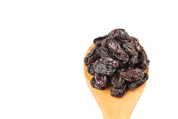 Black raisin on wooden spoon over white background