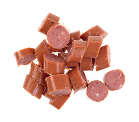 Cut up smoked sausage on a white background