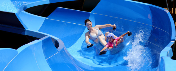 Mother and child having fun in water park